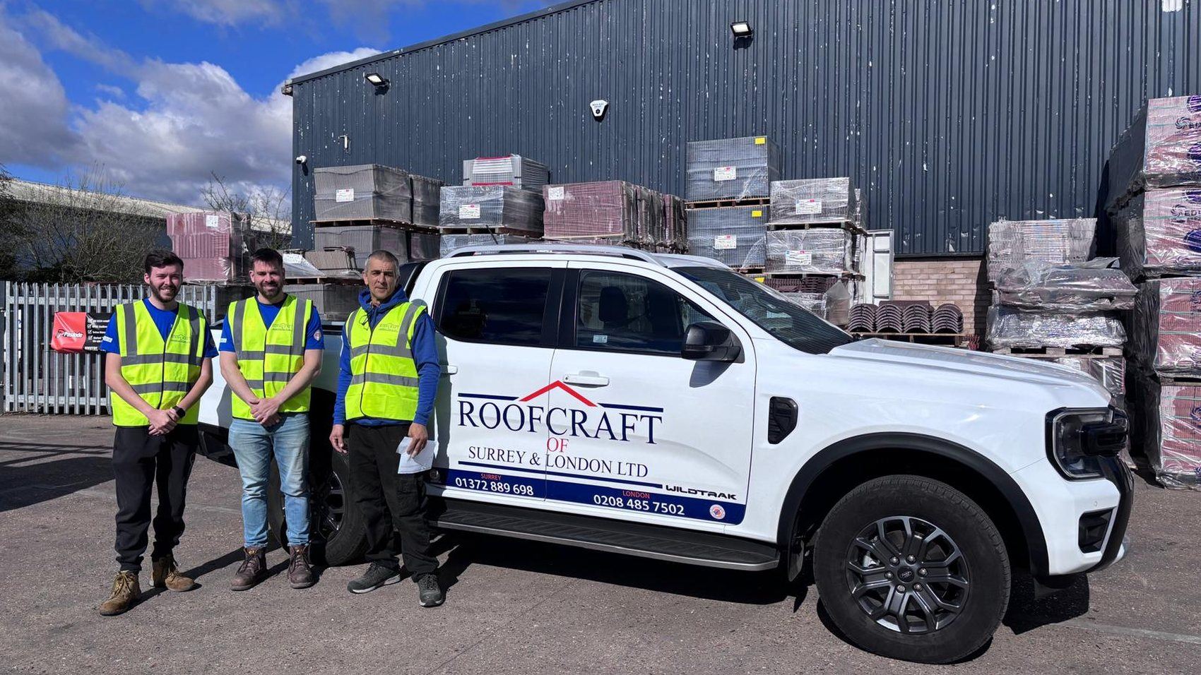 The Roofcraft of Surrey and London team beside their branded vehicle